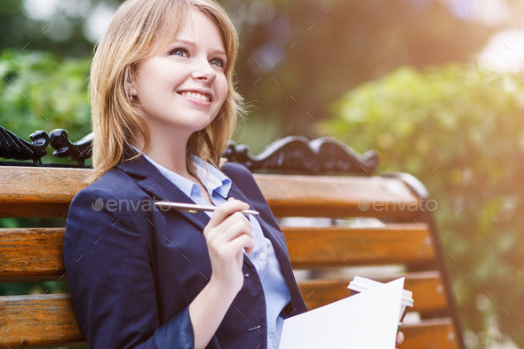 Woman sitting on the bench with diary picture