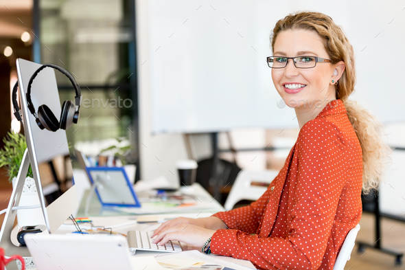 Young woman in casual clothes in an office