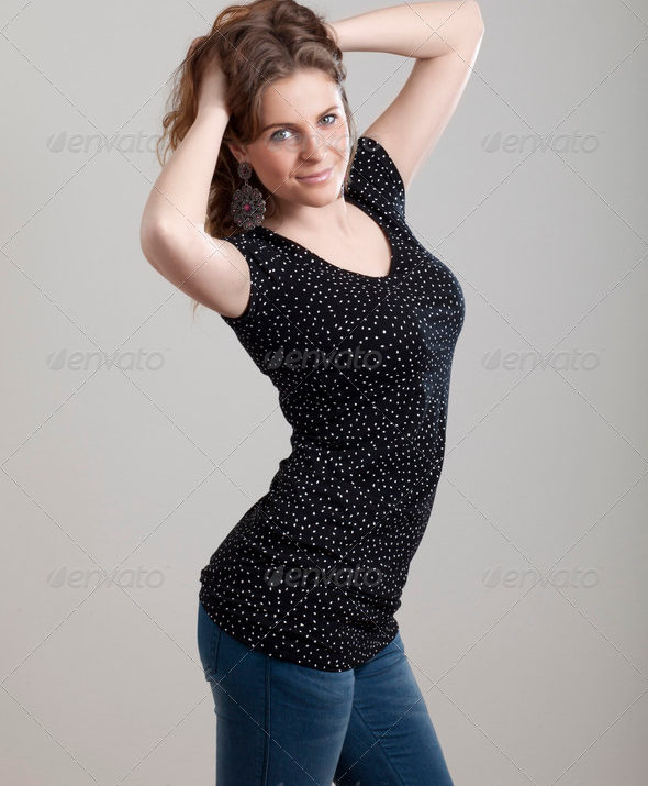 Young Girl Posing in Black Shirt Isolated on Grey Background