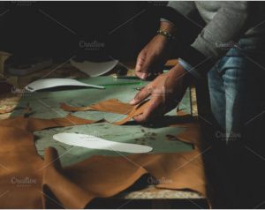 Shoemaker cutting leather