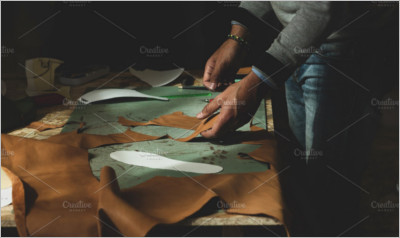 Shoemaker cutting leather